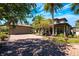 Front exterior view showing brick drive, garage, and mature landscaping with palms and flowering plants at 2112 Shady Ln, Geneva, FL 32732