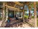 Inviting front porch with brick walkway, pergola, and flowering plants, creating a warm welcome at 2112 Shady Ln, Geneva, FL 32732