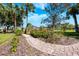 Paver walkway through a garden with tropical trees, flowers, and bushes at 2112 Shady Ln, Geneva, FL 32732