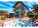 Backyard view featuring a hot tub, patio, and spiral staircase overlooking a scenic yard at 2112 Shady Ln, Geneva, FL 32732