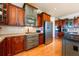 Close-up of kitchen with dual-tone cabinets, stainless steel appliances, and hardwood floors at 2112 Shady Ln, Geneva, FL 32732