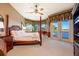 Serene main bedroom with waterfront views, featuring a four-poster bed and access to a private balcony at 2112 Shady Ln, Geneva, FL 32732