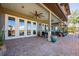 Covered patio with brick flooring, multiple ceiling fans, seating and access to the backyard pool at 2112 Shady Ln, Geneva, FL 32732