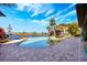 A backyard pool with brick pavers and lush tropical landscaping, offering a scenic waterfront view at 2112 Shady Ln, Geneva, FL 32732