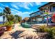 Amazing backyard pool with an outdoor living area, lush plants and landscaping, and waterfront views at 2112 Shady Ln, Geneva, FL 32732