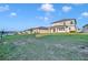 Backyard featuring lush green grass and views of neighboring houses with well-maintained landscaping at 2291 Raven Ridge Rd, Minneola, FL 34715