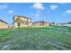 Backyard featuring lush green grass and views of neighboring houses with well-maintained landscaping at 2291 Raven Ridge Rd, Minneola, FL 34715