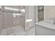 Beautiful bathroom featuring a dual sink vanity, glass shower and neutral tile at 2291 Raven Ridge Rd, Minneola, FL 34715