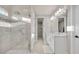 Beautiful bathroom featuring a dual sink vanity, glass shower and neutral tile at 2291 Raven Ridge Rd, Minneola, FL 34715