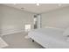 Neutral bedroom with a walk-in shower, natural light and neutral carpet and decor at 2291 Raven Ridge Rd, Minneola, FL 34715