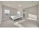 Sunlit bedroom features neutral decor and carpet with walk-in shower in attached bathroom at 2291 Raven Ridge Rd, Minneola, FL 34715