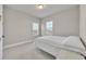 Neutral bedroom featuring two windows and neutral carpet with neutral decor at 2291 Raven Ridge Rd, Minneola, FL 34715