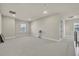 Bright bonus room featuring neutral carpet and light walls with natural light from the windows at 2291 Raven Ridge Rd, Minneola, FL 34715