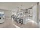 Open concept kitchen with a large island, modern pendant lights, white cabinets and stainless steel appliances at 2291 Raven Ridge Rd, Minneola, FL 34715