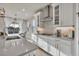 Kitchen featuring white cabinets, stainless steel appliances, and modern light fixtures at 2291 Raven Ridge Rd, Minneola, FL 34715