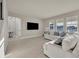 Inviting living room with large windows, neutral tones, and modern tiled flooring at 2291 Raven Ridge Rd, Minneola, FL 34715