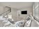 Comfortable living room with ample seating, a mounted television, and abundant natural light at 2291 Raven Ridge Rd, Minneola, FL 34715