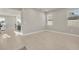 Living room featuring neutral paint, baseboards, wood-look tile floors, and many windows at 2291 Raven Ridge Rd, Minneola, FL 34715