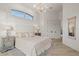 Beautiful main bedroom with neutral tones, chandelier and light wood floors at 2453 Alaqua Dr, Longwood, FL 32779