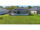 A lovely backyard featuring a screened-in pool and well-maintained lawn at 2487 Ridgemoor Dr, Orlando, FL 32828