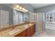 This bathroom features a dual sink vanity, a tiled shower, and a separate soaking tub for a spa-like experience at 2487 Ridgemoor Dr, Orlando, FL 32828