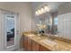 Bathroom featuring a double sink vanity with granite countertops and an outdoor view at 2487 Ridgemoor Dr, Orlando, FL 32828