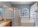 This bright bathroom features a soaking tub, a glass-enclosed shower, and a window for natural light at 2487 Ridgemoor Dr, Orlando, FL 32828