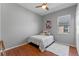 This cozy bedroom offers a comfortable space with hardwood floors and a ceiling fan for a restful night's sleep at 2487 Ridgemoor Dr, Orlando, FL 32828