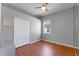 This simple bedroom offers a closet and a bright window, and laminate wood floors at 2487 Ridgemoor Dr, Orlando, FL 32828