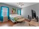This comfortable bedroom features warm wood floors, light-grey walls, and bright-blue curtains at 2487 Ridgemoor Dr, Orlando, FL 32828
