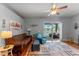 Bright living room with hardwood floors and a sliding glass door view of the pool at 2487 Ridgemoor Dr, Orlando, FL 32828