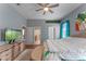 This spacious main bedroom features a ceiling fan, warm floors and an adjacent en suite bathroom at 2487 Ridgemoor Dr, Orlando, FL 32828