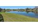 Scenic view of a tranquil pond reflecting the surrounding neighborhood homes at 2487 Ridgemoor Dr, Orlando, FL 32828
