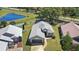 Aerial view of a single-story home with a well-maintained yard and a neighboring pond at 2511 Chatham Cir, Kissimmee, FL 34746
