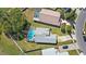 Aerial shot of a home with a screened pool, spacious yard, and manicured landscaping at 2511 Chatham Cir, Kissimmee, FL 34746