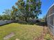 Large, well-maintained backyard features a privacy wall and mature shade trees at 2511 Chatham Cir, Kissimmee, FL 34746