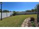 Well-maintained backyard features a privacy wall, stone walkway, and mature landscaping at 2511 Chatham Cir, Kissimmee, FL 34746