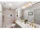 Luxurious bathroom with double vanity, a rain shower, and modern finishes for a relaxing and upscale bathing experience at 2511 Chatham Cir, Kissimmee, FL 34746