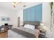 Stylized bedroom with a blue accent wall, desk area, and a comfortable grey upholstered bed at 2511 Chatham Cir, Kissimmee, FL 34746
