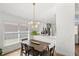 Bright dining area with modern lighting is conveniently located near the kitchen, perfect for easy entertaining at 2511 Chatham Cir, Kissimmee, FL 34746