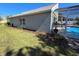 Side view of a well-maintained home featuring a screened-in pool area at 2511 Chatham Cir, Kissimmee, FL 34746