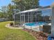 Screened-in pool offers a relaxing oasis with patio area and well-manicured landscaping at 2511 Chatham Cir, Kissimmee, FL 34746
