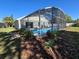 Screened-in pool offers a relaxing oasis with patio area and well-manicured landscaping at 2511 Chatham Cir, Kissimmee, FL 34746