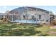 Relaxing screened-in pool area features ample seating and well-maintained landscaping at 2511 Chatham Cir, Kissimmee, FL 34746