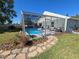 Screened-in pool offers a relaxing oasis with patio area and decorative stone walkway at 2511 Chatham Cir, Kissimmee, FL 34746