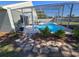 Screened-in pool offers a relaxing oasis with patio area and decorative stone walkway at 2511 Chatham Cir, Kissimmee, FL 34746
