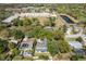An aerial view of a residential neighborhood featuring tree coverage and a nearby park and recreational facilities at 2536 Brookshire Ave, Winter Park, FL 32792