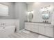 Elegant bathroom features a modern tub, dual sinks, granite countertops and wood look tile flooring at 2536 Brookshire Ave, Winter Park, FL 32792