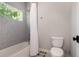 Bathroom featuring a shower-tub combo and simple design elements at 2536 Brookshire Ave, Winter Park, FL 32792