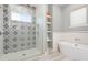 Beautiful bathroom features a tiled shower, a modern tub, and floating shelves at 2536 Brookshire Ave, Winter Park, FL 32792